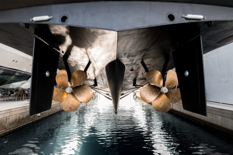Superyacht in dry dock with two propellers.
